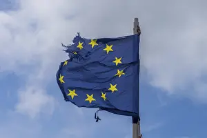 Deserted Coastline England Prints: A torn EU flag blows in the wind with a few clouds in the background
