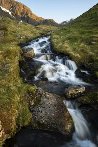 Midnight Sun Norway Prints: A torrent flows down the mountain