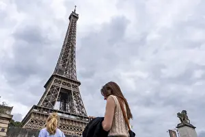 Famous Places In Europe Prints: Two tourists at the Eiffel Tower