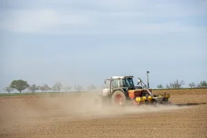 Central European Farmland Prints: Tractor with seed drill in the field in spring