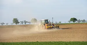 Farming In Southern Germany Prints: Tractor with seed drill in the field in spring