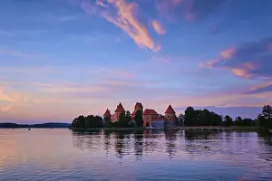 Prints of Trakai Island Castle in lake Galve, Lithuania on sunset with dramatic sky reflecting in water, Lituania Lake Prints: Trakai Island Castle Print, Lithuania at Sunset