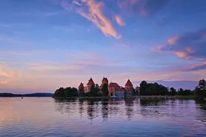Prints of Trakai Island Castle in lake Galve, Lithuania on sunset with dramatic sky reflecting in water. Trakai Castle is one of major tourist attractions of Lituania Lake Prints: Trakai Island Castle Print, Lithuania at Sunset