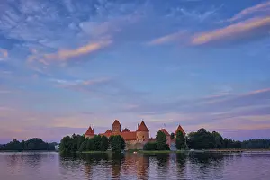 Prints of Trakai Island Castle in lake Galve, Lithuania on sunset with dramatic sky reflecting in water. Trakai Castle is one of major tourist attractions of Lituania Lake Prints: Trakai Island Castle Print, Lithuania at Sunset