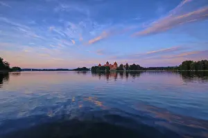 Prints of Trakai Island Castle in lake Galve, Lithuania on sunset with dramatic sky reflecting in water. Trakai Castle is one of major tourist attractions of Lituania Lake Prints: Trakai Island Castle Print, Lithuania at Sunset
