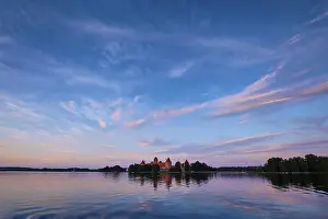 Prints of Trakai Island Castle in lake Galve, Lithuania on sunset with dramatic sky reflecting in water. Trakai Castle is one of major tourist attractions of Lituania Lake Prints: Trakai Island Castle Print, Lithuania at Sunset