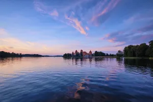 Prints of Trakai Island Castle in lake Galve, Lithuania on sunset with dramatic sky reflecting in water, Trakai Castle is one of major tourist attractions of Lituania Lake Prints: Trakai Island Castle Print - Lithuania Sunset