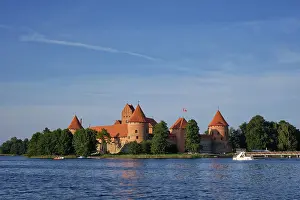 Prints of Trakai Island Castle in lake Galve with boats and yachts in summer day with beautiful sky, Lithuania. Trakai Castle is one of major tourist attractions of Lituania Lake Prints: Trakai Island Castle Print, Lithuania