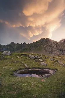 Tranquil Mountain Landscape Prints: A tranquil mountain scene at sunset showcases dramatic