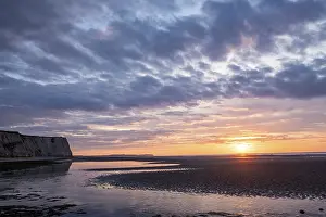 Sandy Ocean Beach Scenery Prints: A tranquil sunset over a sandy beach