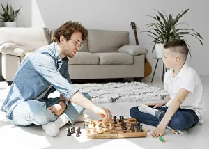 Young Learner Prints: Tutor learning boy how play chess