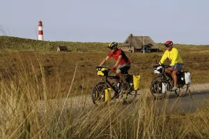 Cyclists in front of the Ostenlager Lighthouse Print