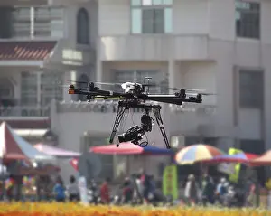 Unmanned Aerial Vehicles Prints: A UAV or drone with a digital camera mounted on it