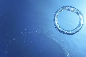 Deserted Waterfront Photo Prints: Underwater Bubble Ring Ascends towards the Sun