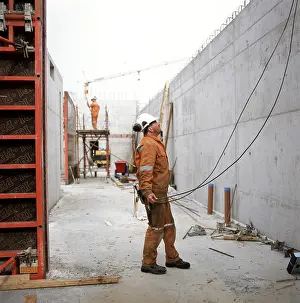 Safety Helmet Prints: Unfinished constructions construction work - setting up a wall