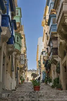 Prints of Valletta, Malta, 23 December, 2023: stairs leading up into the old town center of Valletta with a view of many colourful Gallarija balconies Valletta Prints: Valletta Old Town Print, Malta, 23 December 2023
