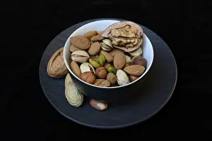 Studio Shot Of Nuts Prints: Various nuts on plates, Germany
