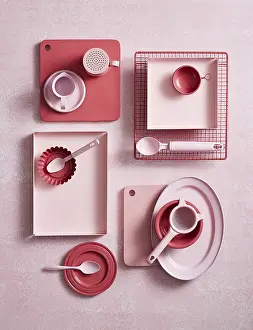 Modern Kitchen Design Prints: Top view of an array of pink kitchen utensils and crockery on a textured surface