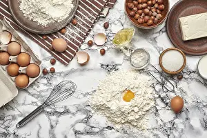 Baking Ingredients Prints: Top view of a baking ingredients and kitchenware on a marble background