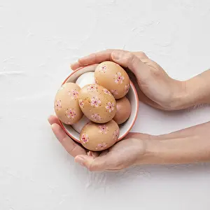 Easter Eggs Prints: Top view bowl with decorated easter eggs hands
