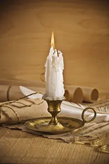 Deserted Office Space Prints: View on the burning candle with old notes sheet