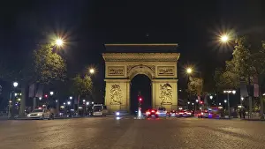 Arc De Triomphe At Night Prints: View along the Champs Elysees of the Arc de Triomphe