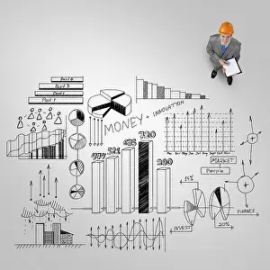 Caucasian Male In Suit Prints: Top view of engineer man with folder and plan sketches on floor