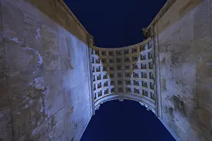 Munich Cityscape At Night Prints: View through a high arcade into the night sky with grid structure