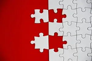 Studio Shot Photography Prints: Top view of missing jigsaw puzzle on red cover background