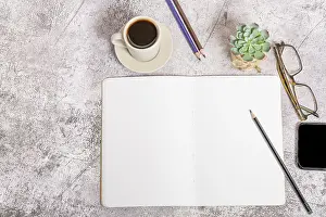 Empty Desk Space Prints: Top view of a notebook with blank pages