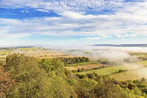 Autumn Color Scenery Prints: View of a patchwork landscape in the countryside with fog above the fields