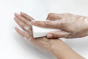 Personal Hygiene Habits Prints: Top view person washing hands with solid soap