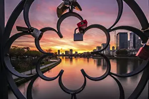 Evening Skyline View Prints: View through a railing with love locks