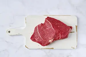 Raw Meat Prints: Top view of raw top side beef steak on marble background