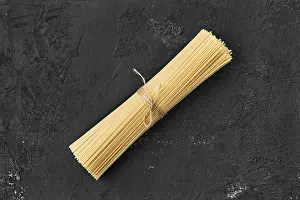 Black Background Food Prints: Top view of raw spaghetti on black background