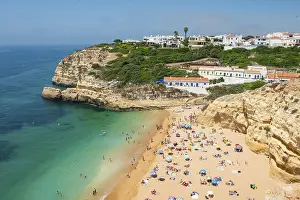 Rock Formations In The Sea Prints: View of sandy beach with bathers