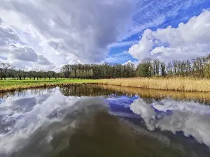 Cloudy Horizon View Prints: View of small rain with dramatic cloud reflections and horizon line