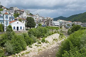 Prints of View of a small town with a river in the foreground, surrounded by wooded mountains and cloudy sky, Echinos, centre of the Pomaks, Myki, Xanthi, Eastern Macedonia and Thrace, Greece River Prints: View of Echinos, Greece Print - Small Town River Landscape