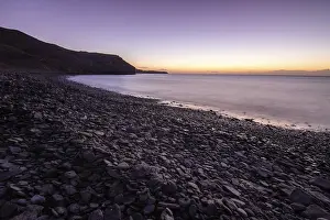 Deserted Stone Beach Prints: View of the sunrise over the Atlantic