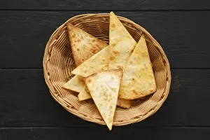 Breakfast Table Setup Prints: Top view of tortilla cut on triangular slices in wicker backet on a table