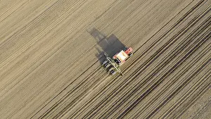 Cornfield Landscape Photo Prints: Above top view, of tractor as pulling mechanical seeder machine over arable field