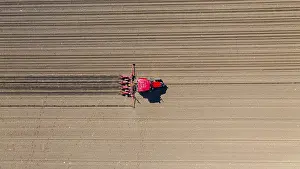 Grainfield Landscape Photo Prints: Above top view, of tractor as pulling mechanical seeder machine over arable field