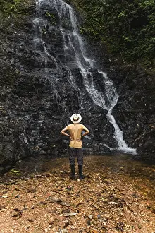 Rainforest Landscape Photography Prints: Back view of an unrecognizable young man
