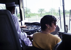 Arabian Peninsula Travel Prints: View through the windscreen of a coach with driver and tour guide, Muscat, Oman, Asia