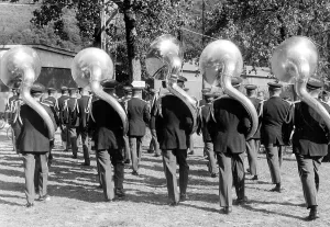 Five large wind instruments in a parade print