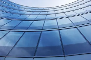 Modern Architecture Prints: Wall of modern building with reflection of sky and clouds