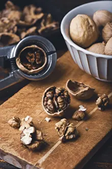 Healthy Eating Habits Prints: Walnuts and nutcracker on wooden surface