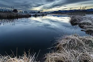 Central Europe Snow Covered Landscapes Prints: Water surface of the Ach with reflection and dramatic sky