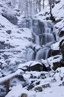 Deserted River Scene Prints: The waterfall is covered with snow