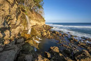 Blurred Motion Waterfall Prints: Waterfall falls into the sea on the cliffs